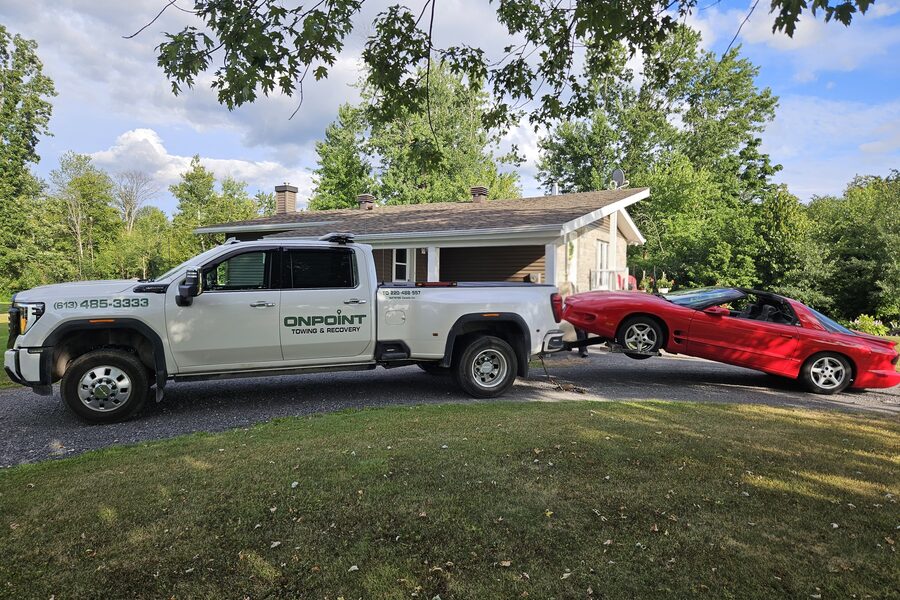 OnPoint Towing recovering a red Pontiac Sunfire
